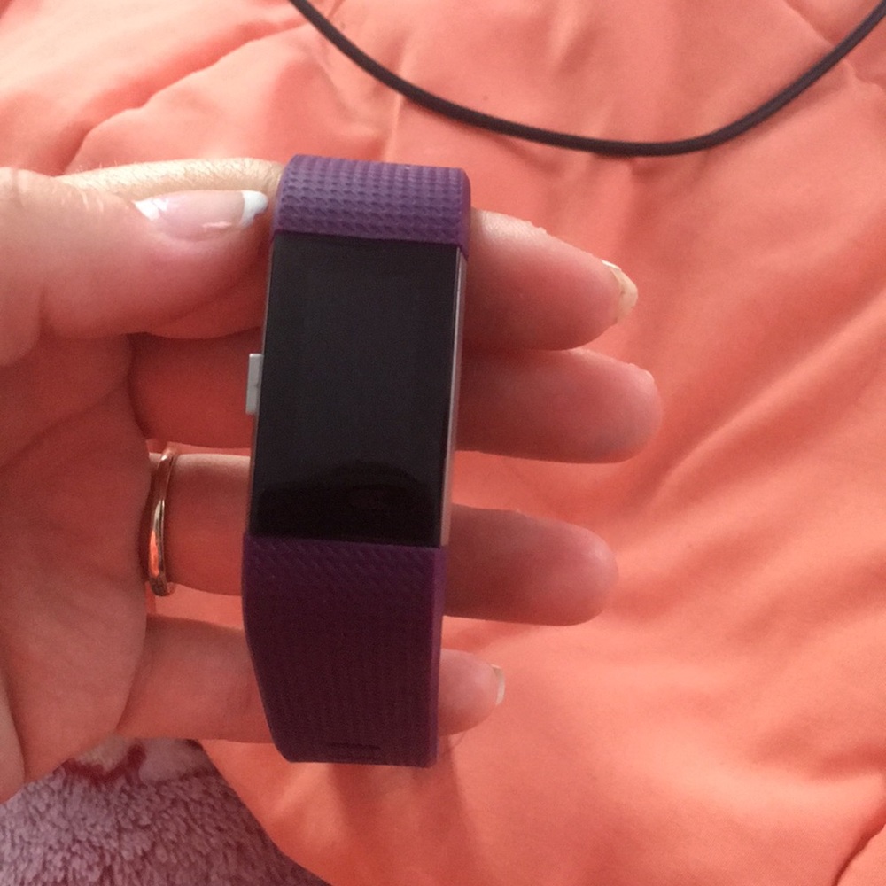 The Real Fit Bit . Purple Fit Bit with charger